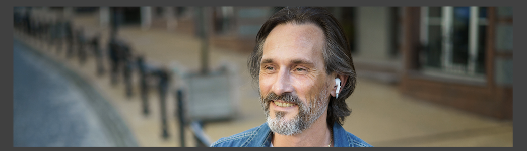 Man with earbuds enjoying digital processing audio features
